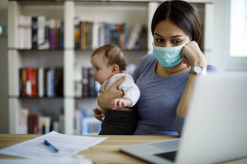 Worried mother with face protective mask working from home blog pandemic pivot current events financial content marketing news