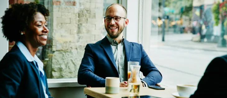 Financial Services Professional with clients in cafe.