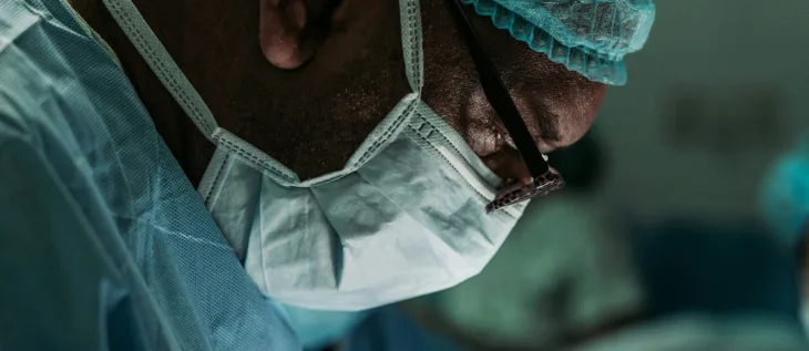 A doctor performing a procedure in a healthcare facility