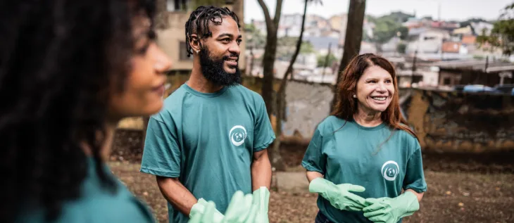 Group of people working with a local nonprofit cleaning up a park