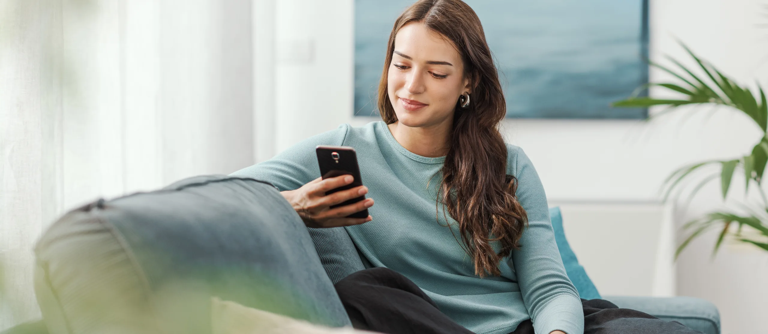 Citadel Credit Union A Citadel Credit Union customer looking at her account on her phone.